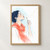 Watercolor-style profile of a woman in a coral scarf holding a dandelion seed head as loose seeds drift to the right.; frame shown for styling only