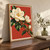 Two ivory magnolia blossoms, a closed bud, and dark-green leaves on a rising branch against a terracotta-red background.; frame shown for styling only
