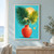 Layered fan-shaped tropical palm fronds in a coral-red vase against a turquoise background with pale sun disks.; frame shown for styling only