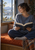 Woman in a blue-gray sweater reading on a rust-colored window seat as a small bird perches outside the open window.