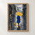 Pedestrian in a blue coat walking away beneath a yellow umbrella on wet stone paving, with an orange cat in a doorway.; frame shown for styling only