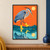 Blue-gray heron wearing yellow rain boots steps through teal water beneath an orange sky and yellow sun.; frame shown for styling only