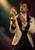 Bearded man in a cream dinner jacket presenting a melting pistachio-and-raspberry gelato cone with a spoon nearby.