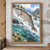 Spotted silver-sided trout with a pink sheen leaping through spray above a rocky river with conifers and distant mountains.; frame shown for styling only