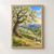 White-blossomed tree scattering petals over a basket beside a stone wall in a sunlit orchard with distant hills.; frame shown for styling only