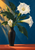 White trumpet-shaped flowers and dark-green leaves in a tall black vase on a coral shelf against a blue wall.