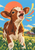 Brown-and-white calf with lifted muzzle and open mouth in a grassy field, beside coral and yellow ribbons, with a barn and fence behind it.