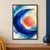 Luminous coral-orange disc enclosed by a sweeping cobalt-blue crescent, with a small golden sphere near its upper tip on a cream field.; frame shown for styling only