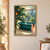 Deep teal freestanding bathtub with steam and a coral towel in a bright glass conservatory, framed by broad green foliage and rain-streaked windows.; frame shown for styling only