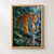 Orange-and-black tiger stepping through a shallow jungle stream amid broad green leaves, with a waterfall behind.; frame shown for styling only