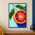 Close-up cut blood orange with ruby-red segments and water droplets, leafy twig, pale aqua background, and cobalt corner.; frame shown for styling only