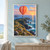 Orange and coral striped hot-air balloon above a rugged coastal headland, winding cliff path, distant lighthouse, and blue sea at sunrise.; frame shown for styling only