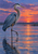Blue-gray heron standing in shallow water with a reflection beneath a coral-violet sunset.