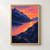Painterly sunset with a golden sun and coral-orange water between dark violet mountain ridges.; frame shown for styling only