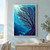 Dark branching coral fan with three small silvery fish, bubbles and sunbeams in bright turquoise water.; frame shown for styling only