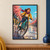 Helmeted cyclist in a mustard jacket riding a teal bicycle through a puddle past storefronts and pink flowering trees.; frame shown for styling only