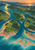 Aerial view of a teal river branching through green islands toward a coral-and-aqua estuary, with a small white sailboat and sunset mountains.