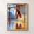Two burgundy-red ballet slippers hanging by their ribbons from a wooden barre, reflected on a studio floor under blue and warm light.; frame shown for styling only