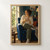Adult woman holding a steaming cup in a deep blue armchair beside a bright window, with a rust-red cushion.; frame shown for styling only