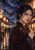 Fictional woman in a plum garment with an indigo scarf streaming behind her in a rainy, warmly lit night market.