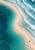 A winding pale sandbar between a turquoise lagoon and foamy surf, lined with tiny shorebirds and a small red parasol.