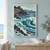 Turquoise curling wave beside a rocky coastal village, red-sailed fishing boat, and white seabirds.; frame shown for styling only