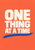 Cream block capitals reading “ONE THING AT A TIME” on a coral-orange background above a cobalt-blue brushstroke.