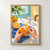 Two hands peel a ripe orange beside a glass of sparkling water on a sunlit table, with a blue cloth and bowl of oranges.; frame shown for styling only