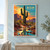 Two-armed saguaro cactus before an apricot sunset and mesas, with turquoise reflective water and the title DESERT AFTER RAIN.; frame shown for styling only