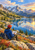 A hiker in a scarlet cap and blue jacket sketches beside a reflective alpine lake beneath jagged mountains and a glowing sunset.