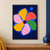 Six-petal geometric flower rosette in saffron, coral, green and pale pink, with a violet center and detached blue circle on indigo.; frame shown for styling only