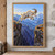 White mountain goat leaping between rocky alpine ledges above a gorge with distant mountains.; frame shown for styling only
