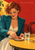 Woman with copper curls in a teal jacket arranging a blood-orange slice beside a sparkling-water glass on an ochre café table.
