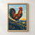 A copper-and-indigo rooster crowing on a rocky ridge beneath a rising sun, with distant hills and a dark border.; frame shown for styling only