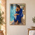 Adult woman in a deep-blue robe seated on a stone pool ledge and squeezing water from a towel beside turquoise water.; frame shown for styling only