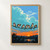 Seven sparrows perch on a sagging dark wire beneath a turquoise cloud and orange sunset, above dark foliage and reflective water.; frame shown for styling only