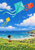 Child seen from behind flying turquoise, vermilion and yellow kites over a flowered meadow beside a beach and distant sailboats.