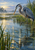 A gray-blue heron stands among marsh reeds with one foot raised over rippling water and a small fish beneath the surface.
