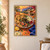 Ceramic platter of flatbread, olives, figs, white cheese, and pomegranate on a terracotta table, with a hand offering olives and a sunset coast behind.; frame shown for styling only