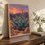 A large blue-green rosette succulent with a tall stalk of coral hanging blooms among desert stones and yellow-orange flowers at sunset.; frame shown for styling only
