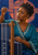 Portrait of a woman lifting a thread beside a small upright loom against an indigo and coral background.