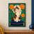 A calico cat raises one paw from a round dark-blue cushion among orange marigolds and green foliage.; frame shown for styling only