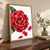 Large layered red flower with a reflective bead at its center, dark green leaves and three detached petals on a white background.; frame shown for styling only