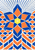 Six-part geometric rosette in blue and apricot with a yellow center, dotted upper rays, scalloped side bands, and lower chevrons on an off-white ground.