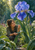 An adult woman crouches among wet green leaves beneath a large blue-violet iris, examining a droplet in filtered sunlight.