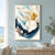Large white magnolia with a golden center above a curved indigo brushstroke and coral-pink buds on a pale aqua background.; frame shown for styling only