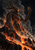 Towering root-crowned ember spirit reaching toward a bright spark over volcanic ridges, smoke and orange lava.
