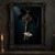 Pale moth resting across an ornate dark silver key with a deep red stone and black bow, with a chain looping over a dark teal background.; frame shown for styling only