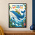 A smiling blue whale carries flowers, greenery, and a red pennant beneath the words “GROW YOUR OWN WONDER.”; frame shown for styling only