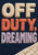 Three lines of raised fabric lettering read OFF DUTY, DREAMING on navy woven cloth, with an ivory quilted blanket corner at lower right.